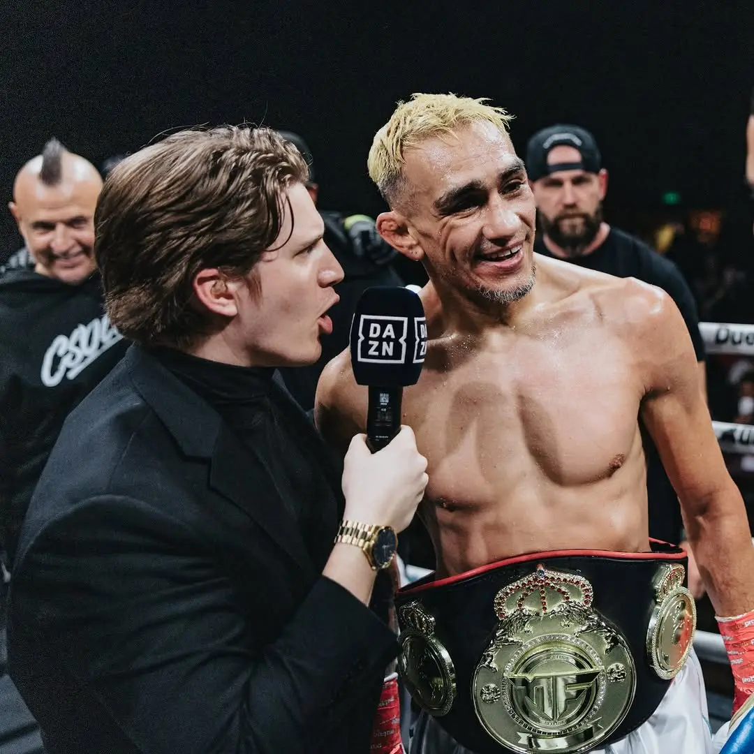 Ben Davis interviewing Tony Ferguson in the ring with a DAZN microphone